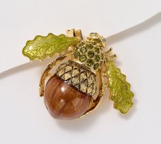 Add instant charm (and subtle symbolism) to any fall outfit with this buzz-worthy acorn bee pin designed with accented with transparent brown and green epoxy and olive green crystals. From the Joan Rivers Classics Collection®. Bee Pin, Crystal Eye, Brown And Green, Joan Rivers, Jewelry Pins, Silver Shop, Green Crystals, Fine Jewellery Necklace, Ankle Bracelets