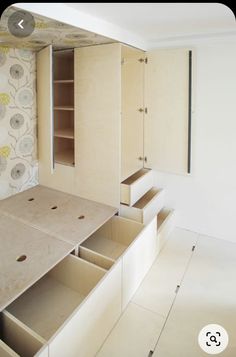 an empty room with drawers and cabinets in it