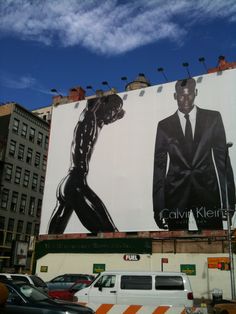 a large advertisement on the side of a building with a man in a suit and tie