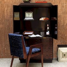 a wooden desk with a blue chair next to it and a clock on the top shelf