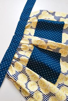 two pieces of fabric are laying next to each other on a table with blue and white polka dots