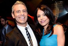 a man and woman are posing for a picture at an event in front of other people