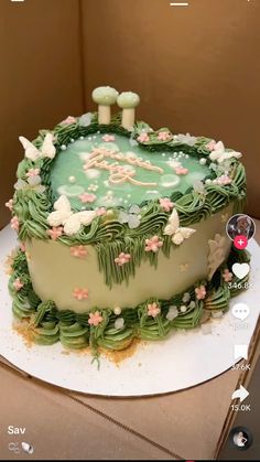 a cake with green frosting and flowers on it