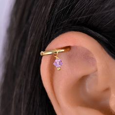 Conch huggie hoop earring. The hoop has a crystal bead. There are many different colors to choose from. The charms are detachable so if you would like more than one color you can order a set so you can easily change the colors. Huggie Clicker Hoop - Gold plated surgical stainless steel (18g) Adjustable Small Hoop Pierced Ear Cuff, Adjustable Dangle Hypoallergenic Ear Cuff, Adjustable Hypoallergenic Dangle Ear Cuff, Hypoallergenic Adjustable Dangle Ear Cuff, Adjustable Small Hoop Single Ear Cuff, Pierced Small Hoop Ear Cuff Gift, Small Hoop Pierced Ear Cuff As Gift, Pierced Hoop Ear Cuff As A Gift, Adjustable Huggie Wrap Earrings For Pierced Ears