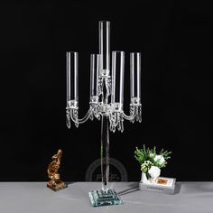 a crystal candelabra with five candles and a small figurine next to it