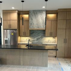 an empty kitchen with wooden cabinets and stainless steel counter tops is seen in this image