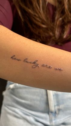 a woman with a tattoo on her arm that says, you are one