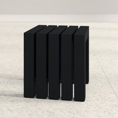 four black rectangular objects sitting on the floor