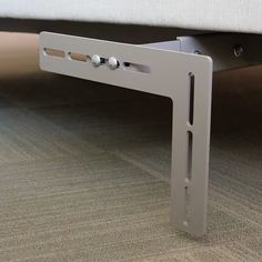 a close up of a bed frame on the floor with no headboard or foot board