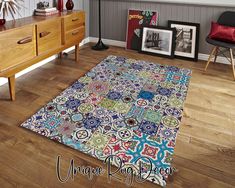 a blue and white area rug on the floor in a room with wooden furniture, framed pictures, and other items