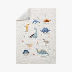 a baby quilt with dinosaurs on it and the words, i love you in different languages