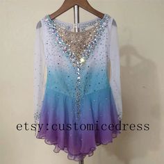 a purple and blue dress with sequins on the top is hanging on a hanger