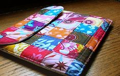 a colorful wallet sitting on top of a wooden table