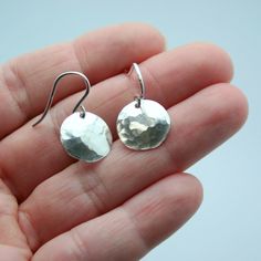 Easily transition from the office to happy hour with these handmade hammered disc earrings. They are very lightweight and make a great everyday earring for all seasons and all ages. Extra Large - 1 1/4 inches in diameter Large - 1 inch in diameter Small - 1/2 inch in diameter (shown on model) All pieces will be packaged together in a cotton filled jewelry box unless otherwise specified. Please let us know if your order is a gift and we will gladly include a handwritten note and complimentary gift wrap. Earrings Circle, Hammered Earrings, Gold Disc, Disc Earrings, Everyday Earrings, Happy Hour, Gift Wrap, All Seasons, The Office