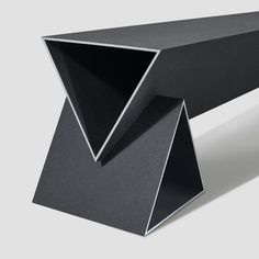 a black table with an angled design on it's top and the bottom section is folded in half