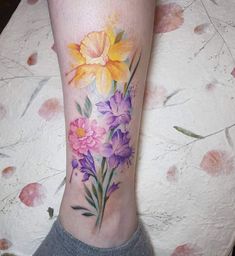 a woman's leg with flowers painted on it