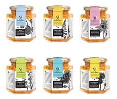 six jars of honey with labels on them