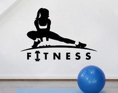 a wall decal that says fitness with a woman doing yoga on the floor next to a blue exercise ball