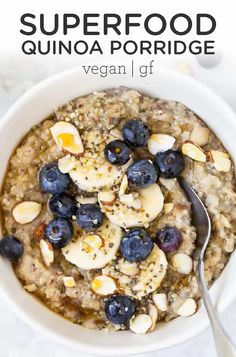 a bowl of oatmeal with blueberries and almonds on top is shown