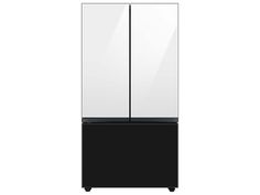 a black and pink refrigerator freezer sitting on top of a white floor next to a wall