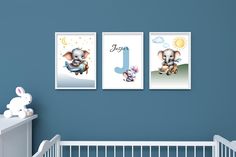 a baby's room with three pictures on the wall