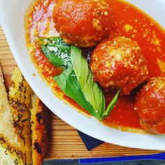 meatballs in tomato sauce with basil and bread on the side, ready to be eaten