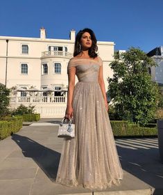 #PriyankaChopra pulled out ALL the stops for Harry and Meghan's royal wedding reception at Frogmore House. Making the most major of outfit changes, Chopra stunned in a #sparklydress A-line off-the-shoulder #formalgown. #eveningdress #celebritydress Wedding Reception Outfit, Reception Gowns, Reception Outfit, Reception Gown, Wedding Reception Dress, 90's Fashion, Cocktail Gowns, Indian Gowns, Engagement Dresses