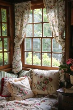 a living room filled with lots of furniture next to a window covered in floral curtains