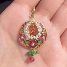 Featured is a pendant only made in 22k gold, studded with rubies, emeralds and pearls. The pendant weighs 4.40 gms including 0.23gms in the hanging ruby-emerald beads. The pendant is sold without the chain. Price Breakup Summary Component Rupees % of Total 22k Gold 19,510 74.9% Stones & Beads 2,277 8.7% Making Charges 3,512 13.5% Taxes (GST) 759 3.0% Total 26,057 100.0% View Detailed Price Breakup 22k Gold Kundan Pendant Necklace In Yellow Gold, Yellow Gold Kundan Pendant Necklace For Celebrations, 22k Gold Kundan Pendant Necklace For Celebration, Kundan Gold Pendant Necklace For Celebration, 22k Gold Jewelry Necklaces, Delicate Pendant, 22k Gold Jewelry, Pearl Necklace Set, Emerald Bead