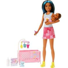 a doll holding a baby in her arms next to a toy crib and toys