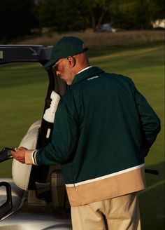 a man standing next to a golf cart