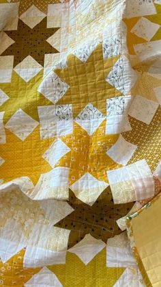 a yellow and white quilt with stars on it