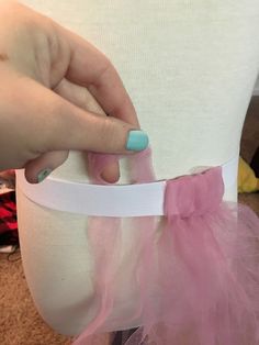 a woman's hand is on the waist of her tutu skirt