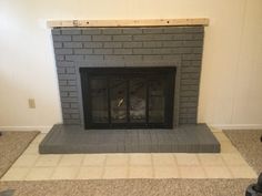 a brick fireplace is being installed in a living room with carpeted flooring and white walls