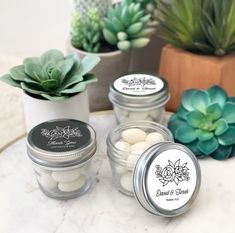 mason jars filled with wedding favors and succulents