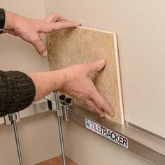 an older woman is holding onto the back of a wall