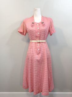 "Beautiful pale pink 1950s shirtwaist dress. The fabric is fairly sheer with a grey horizontal stripe and a subtle white vertical stripe and well as a gold metallic thread horizontal stripe running through it. Love the details in the bodice and the neckline. Narrow square neckline with loops coming down off the sides. Beautiful buttons. The dress comes with lovely dangling rhinestone dress clips that clip into the loops at the neckline. Note: If you are interested in just the dress of just the r 1950s Style Pink Vintage Dress, 1950s Style Pink Dress For Vintage Events, 1950s Style Pink Formal Dress, Pink 1950s Style Formal Dress, 1950s Style Pink Dress For Vintage Fashion, Retro Pink Vintage Dress For Daywear, Pink Retro Vintage Dress For Formal Occasions, Pink 1950s Vintage Fashion Dress, Pink 1950s Vintage Style Dress