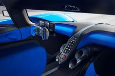 the interior of a sports car with blue and black trims, steering wheel controls and dashboard