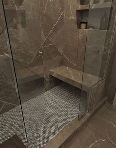 a walk in shower sitting inside of a bathroom next to a tiled floor and walls