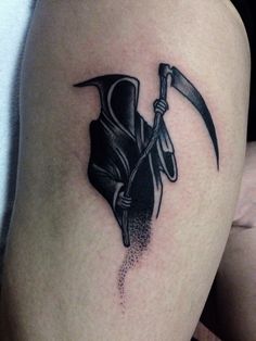 a person with a tattoo on their leg holding a knife