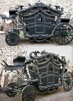 an old fashioned horse drawn carriage sitting in front of a stone wall