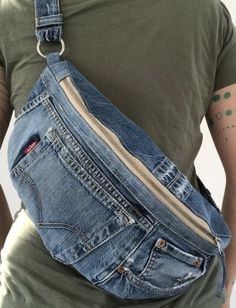 a man wearing an old pair of blue jeans with a zippered pocket on his back