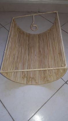 an umbrella made out of straw sitting on the floor