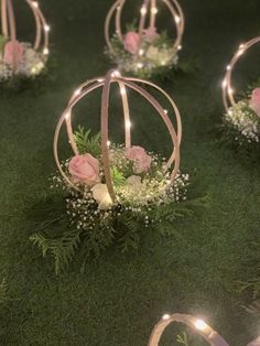 flowers and lights are placed in small balls on the grass