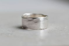 a silver ring sitting on top of a white counter next to a gray wall and floor