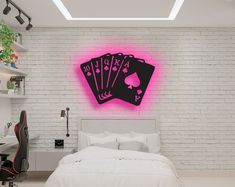 a room with a bed, desk and neon sign on the wall that says poker