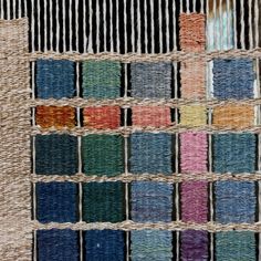 several different colors of thread are arranged on a piece of jute material that has been woven into it