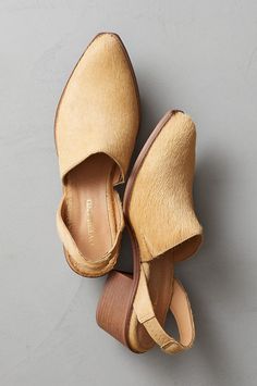 You'll make your presence known as soon as you step into a room in the chic Gina mules. These silky, hair-on calfskin leather slingbacks are timelessly fashionable and comfortable to boot, thanks to their stacked heel, elastic-paneled rear strap, and slip-on upper. Featuring gentle traction on the soles and pigskin leather lining. Luxury Leather Sole Mules For Fall, Luxury Leather Footbed Mules For Spring, Cheap Flat Heel Mules For Fall, Luxury Leather Slip-ons For Fall, Luxury Suede-lined Mules For Work, Luxury Slip-on Mules With Wooden Heel, Luxury Leather Slip-on Shoes For Summer, Luxury Chic Calf Leather Shoes, Luxury Leather Slip-ons For Spring