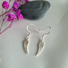 ♡Gorgeous little pair of silver plated angel wings handmade with 925 sterling silver earring hooks. Earring nuts are made from hypoallergenic silicone. ♡Earring drop - 25mm and width 5mm. Check out photos for size guide.  ♡Dainty earrings perfect for everyday wear or as a gift and come with a lovely velvet gift pouch.  ♡Due to individual monitors colours may vary but please contact me with any queries.  Thanks for checking out my etsy shop 🙂 Elegant Winged Earrings For Gift, Sterling Silver Ear Wire Earrings As Gift For Her, Hypoallergenic Sterling Silver Earrings For Her, Hypoallergenic Sterling Silver Earrings As Gift For Her, Handmade Winged Earrings For Gifts, Winged Jewelry With Ear Wire For Gifts, Winged Sterling Silver Earrings As Gift, Winged Sterling Silver Earrings For Gift, White Wing-shaped Earrings For Gift