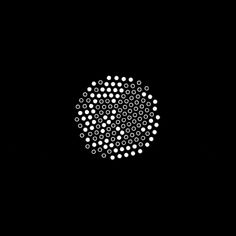 a black background with white circles in the middle and one circle at the top that is circular